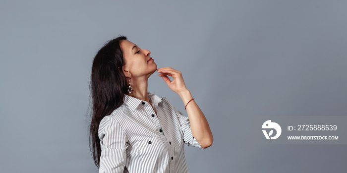 middle-aged woman holds her hand near her chin