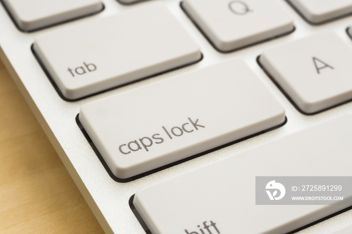 Close up caps lock button on white keyboard.