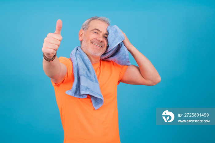 adult or senior man sweating doing sports isolated on color background