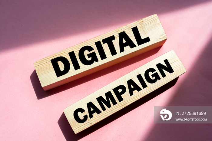 Digital Campaign written on a wooden blocks on pink. Online business advertising marketing concept