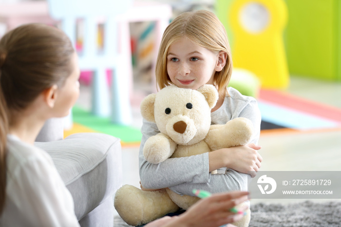 Young female psychologist working with teenager girl in office