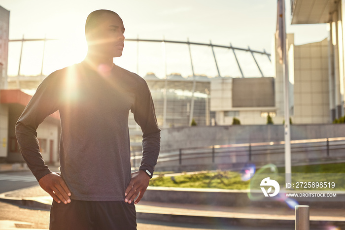 What a great day for workout! Athletic african man with a muscular body standing with arms on his hi