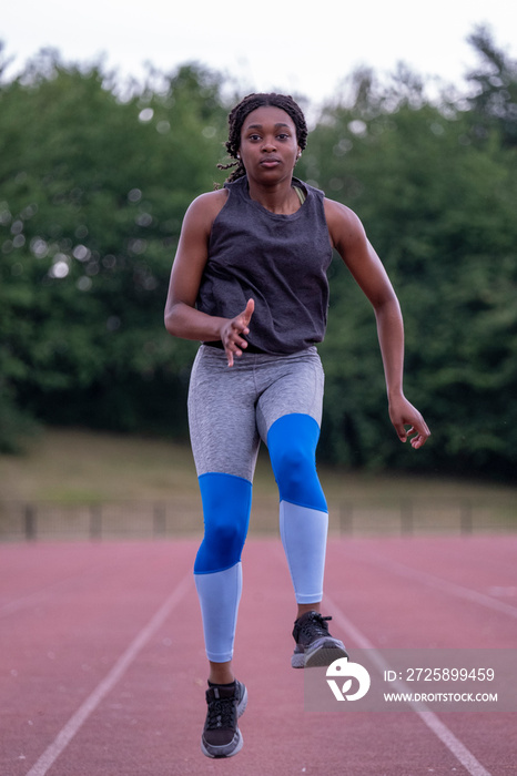 Athletic�woman running on track