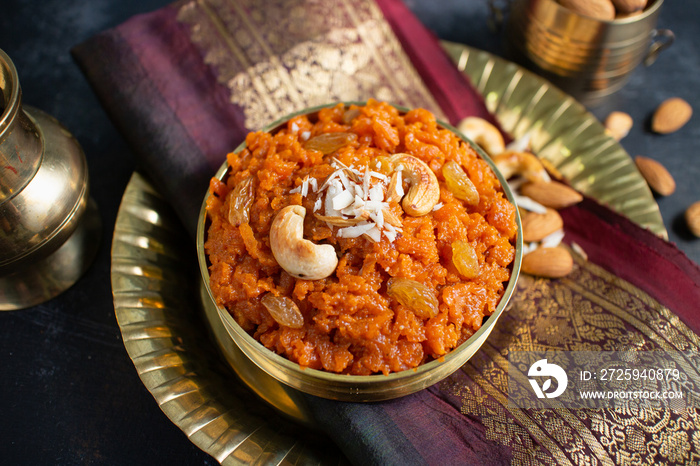 Indian Sweet carrot Halwa or Halva dessert festival sweet served in golden bowl  Mumbai, India for D