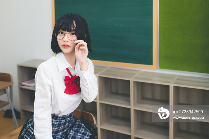 Cute short haired Asian girl Thai people wearing glasses and Japanese school uniforms and trying to 
