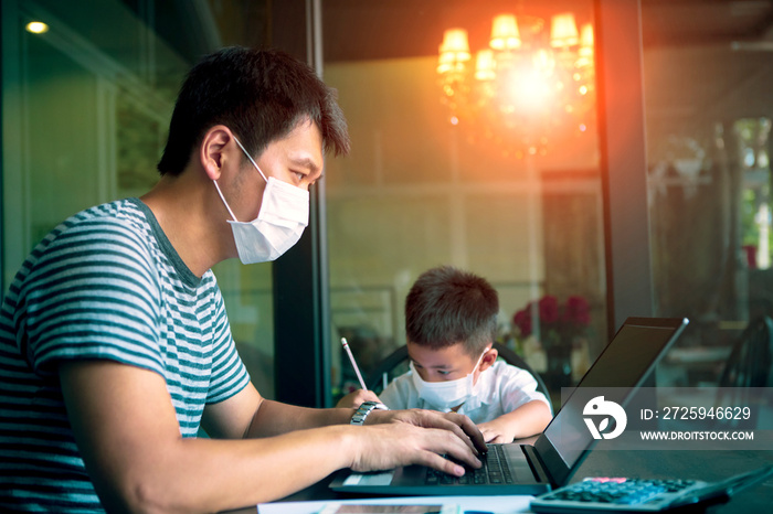 隔离亚洲男子和儿童戴着防护口罩在家里电脑上工作，而新冠肺炎