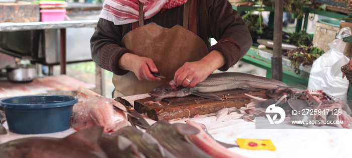 Colorful view of fresh raw fish on the market. Scene with people at work in the street market. Fast 