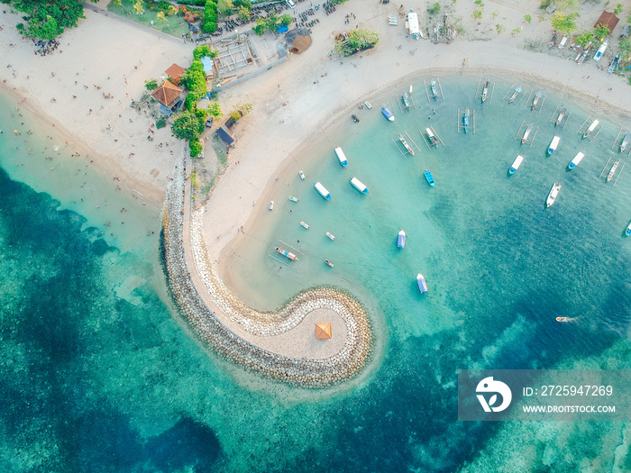 Aerial drone view of ocean, boats, beach, shore In Sanur Beach, Bali, Indonesia with with Traditiona