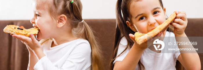 Young girls eating pizza