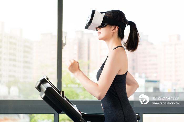 beauty asian woman running treadmill by VR headset glasses