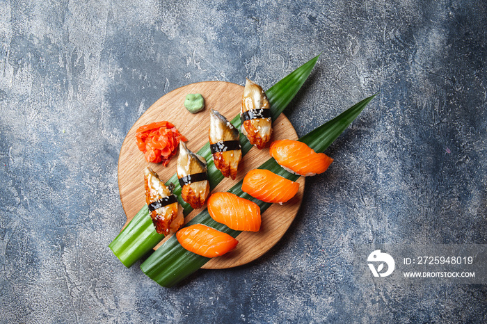 Sashimi sushi set on wooden board. Stone background. Top view