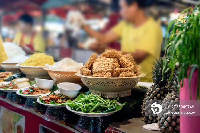 noodles and traditional Thai food are served in portions at an open market in Phuket, local fast foo