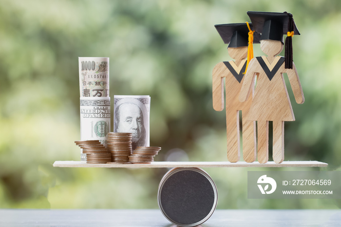 University Education learning abroad international Idea. Student Graduation save coins US dollar,JPY on wood round box balance. Concept of study requires money cost saving for success. Back to School