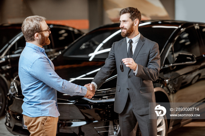 Client with a salesman at the showroom with electric cars