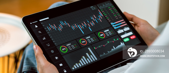 Stock exchange market concept, Hand trader touch on digital tablet with graphs analysis candle line 