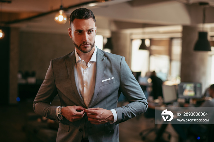 Portrait of attractive businessman in gray suit