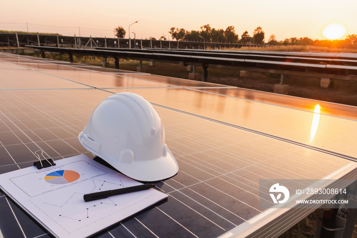 Engineers hat and the graph are placed on the solar panel, alternative electricity source, concept o