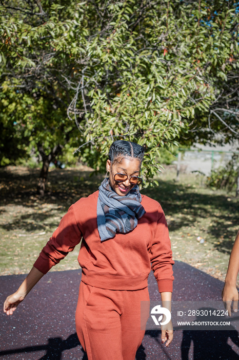 Black woman laughing in park in fall