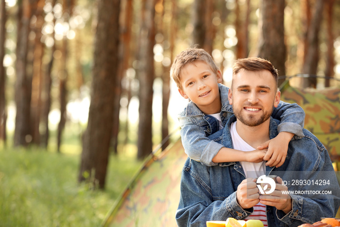 Father and his little son spending weekend in forest