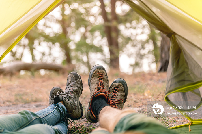 Feet in boots in tent opening