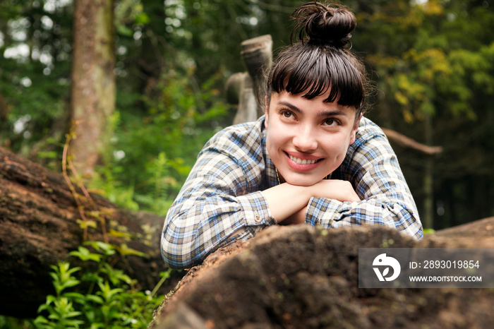 Portrait of smiling woman in forest