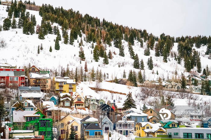 Houses and cabins on a mountain blanketed with snow in Park City Utah in winter