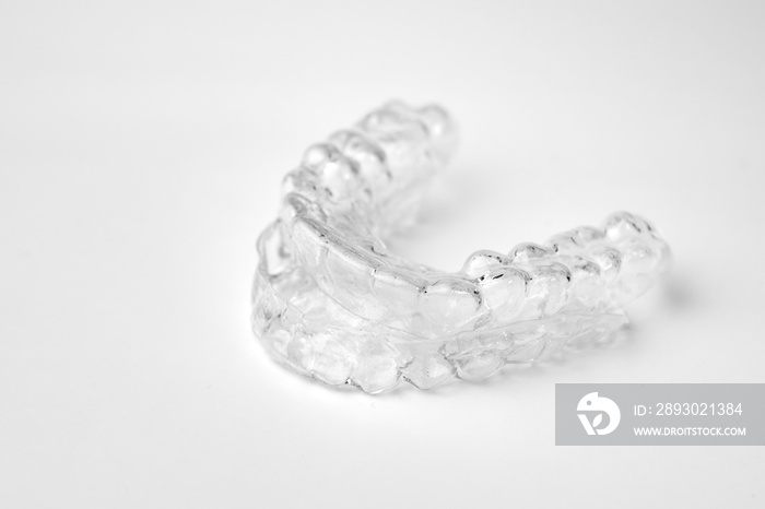 Invisible orthodontic removable braces on a white background with copy space. Aligners for straighte