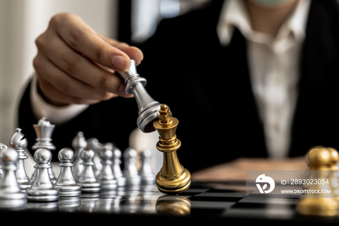 Person playing chess board game, conceptual image of businesswoman holding chess pieces against oppo