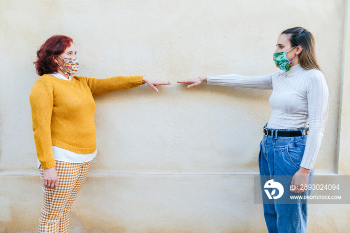 Two women with face masks representing social distancing