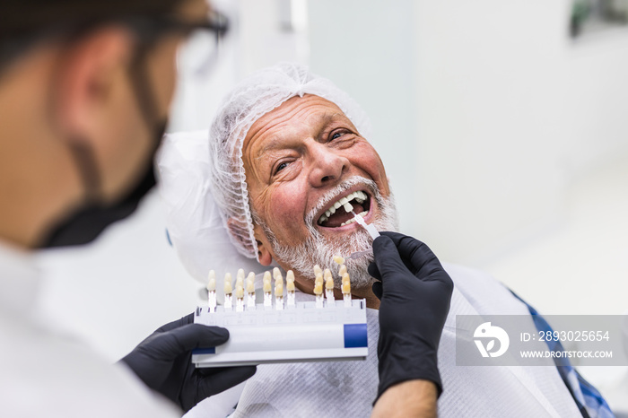 Senior man having dental treatment at dentists office.