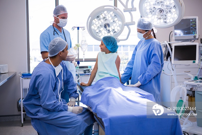 Doctor interacting with patient in operation room