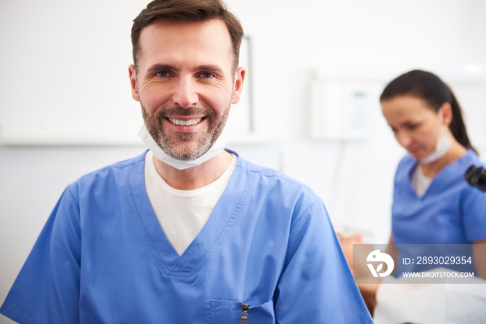 Portrait of smiling male dentist in dentists clinic