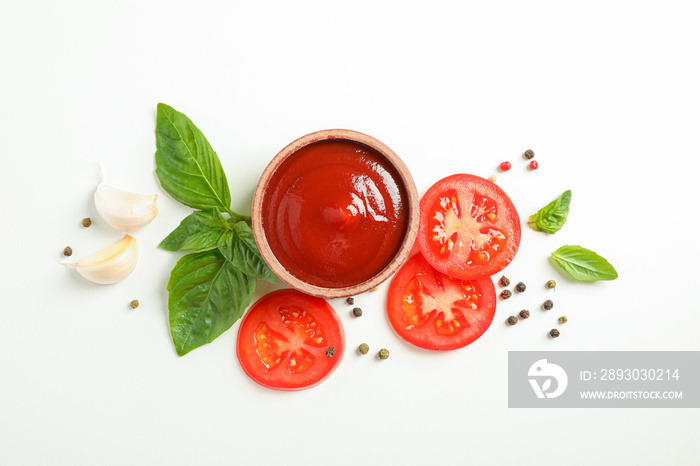 Flat lay composition with fresh cherry tomatoes slices, basil, pepper, garlic and sauce on white bac