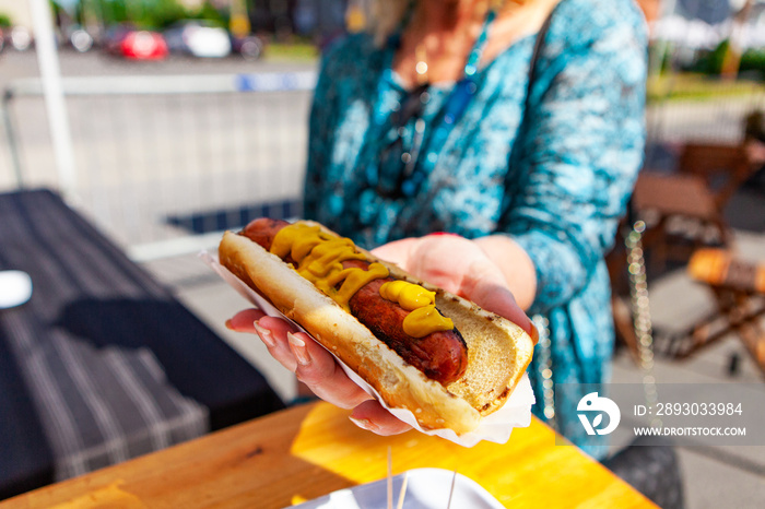 Ordering a hot dog at the market. Close up picture shot outside on a sunny day in a french farmers 