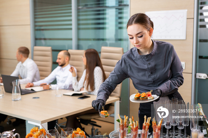 waiter serving a banquet in the office