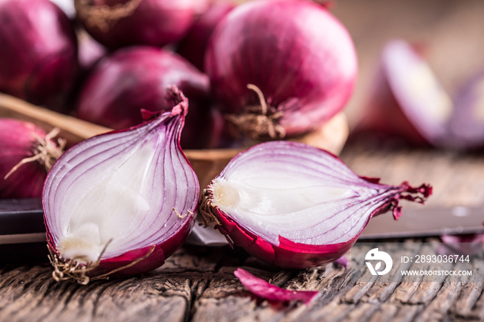 Onion. Red onions on very old oak wood board. Selective focus.