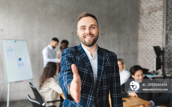 Successful Young Entrepreneur Stretching Hand For Handshake Standing In Office