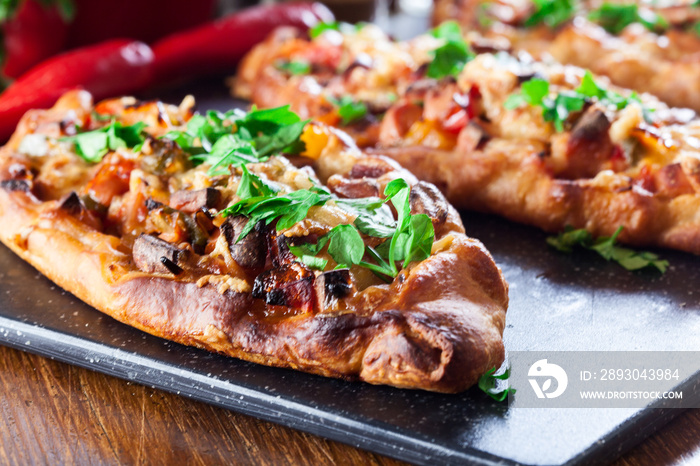 Traditional Turkish pide with meat and vegetables