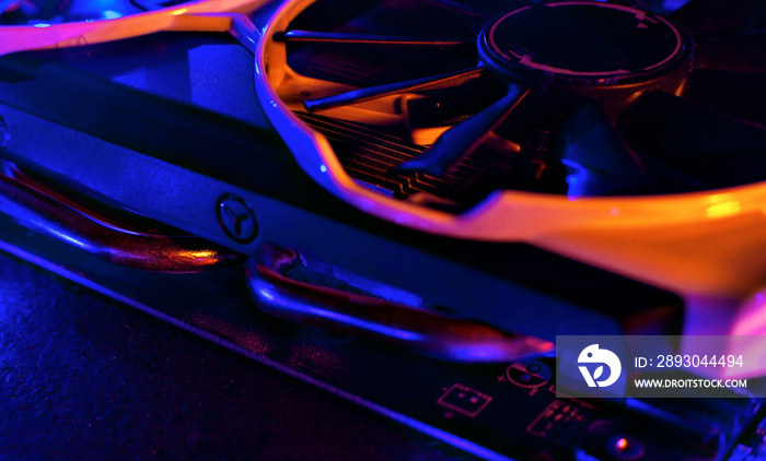 Graphics card in neon light. Cooling in a computer. Fan blade