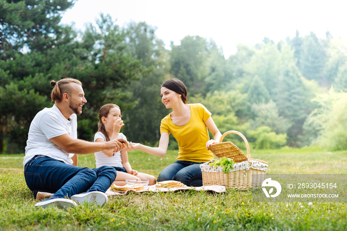 Happy close-knit family enjoying picnic in the park