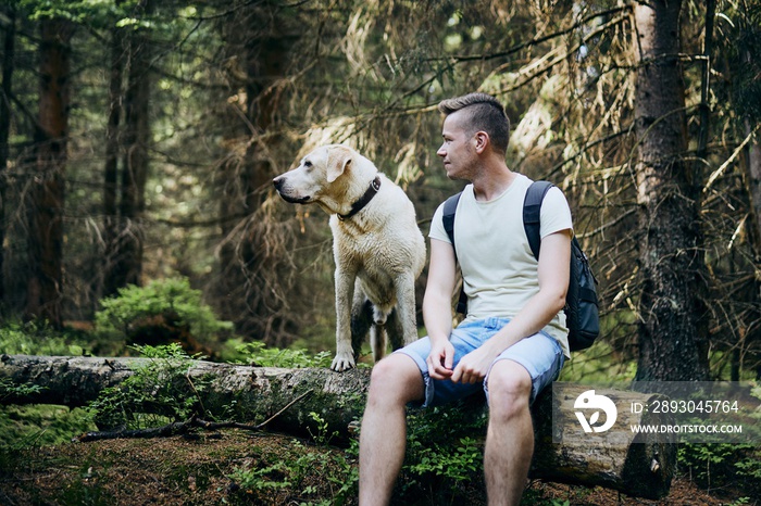 Tourist with dog in forest