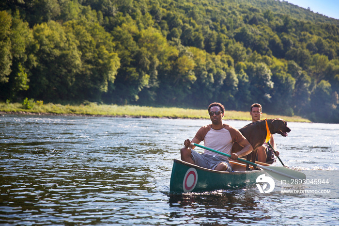 Friends canoeing in river