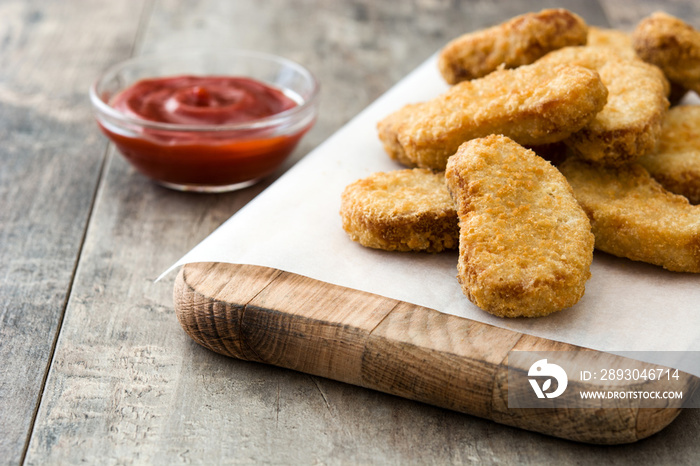 Fried chicken nuggets on wooden table