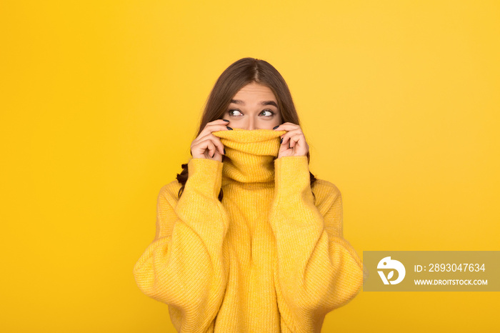 Woman having fun, looking out from sweater