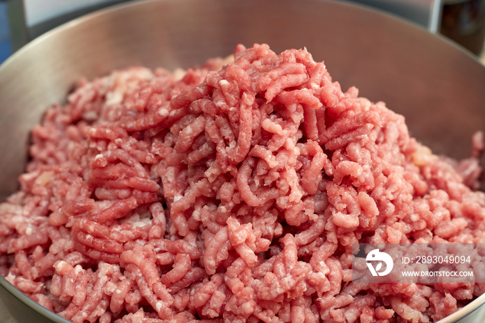 Minced meat in a large metal bowl. Close-up