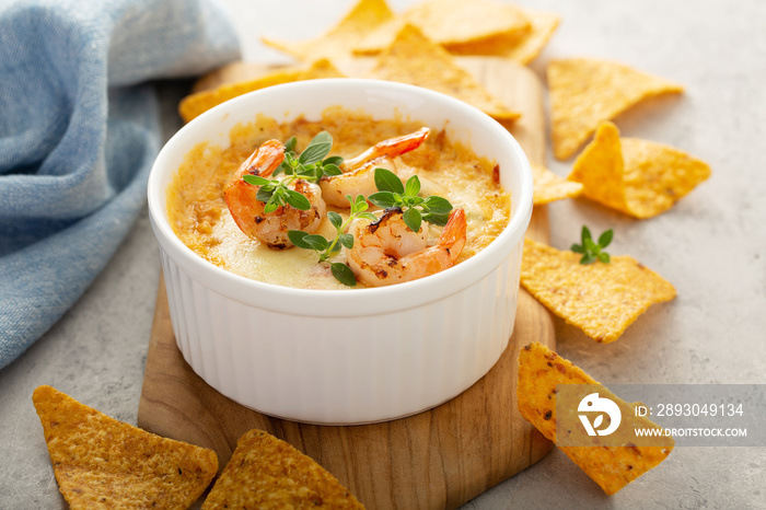 Spicy seafood dip in a ramekin with corn chips