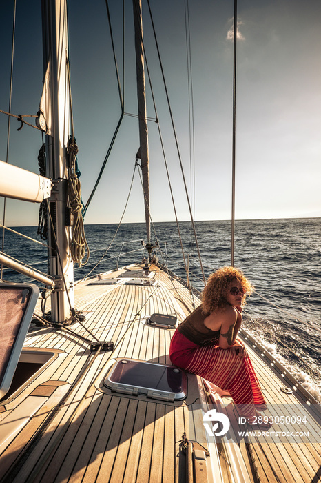 Travel people influencer social media concept with cute curly young adult woman sit down on a sail b