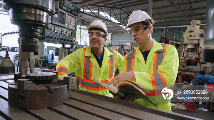 Group of factory workers using machine equipment in factory workshop . Industry and engineering conc