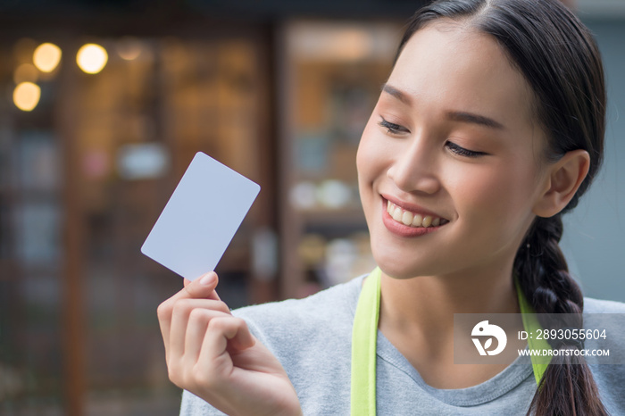 asian woman business owner showing blank credit card