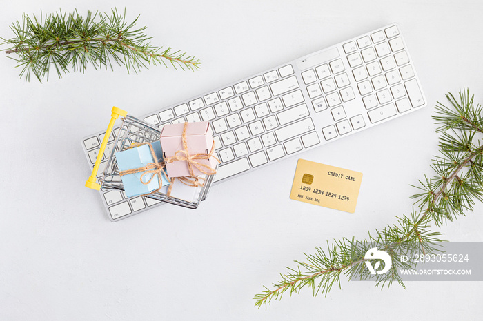 Online christmas shopping concept with gift boxes, keyboard and golden credit card